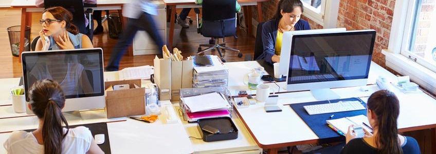 group of women working with mac computers